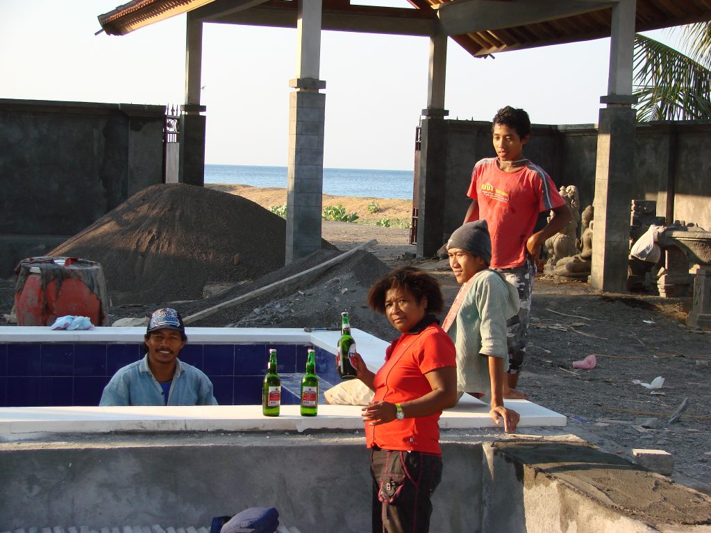 Mary Afdan drinking beer with the workmen at Villa Sinar Cinta